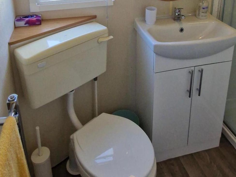 A bathroom with a toilet and sink at Woodland View Dog Friendly Nr Sutton on Sea Thurlby near Alford