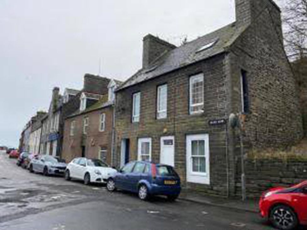 A street view of buildings and parked cars at Wick Harbour Apt 2 Bed Fast WiFi NC500 Wick, Caithness