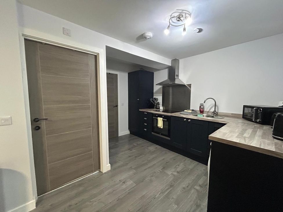 A kitchen with cabinets, an oven, and a sink at Wick Harbour Apt  2 Bed  Fast WiFi  NC500, Wick, Caithness