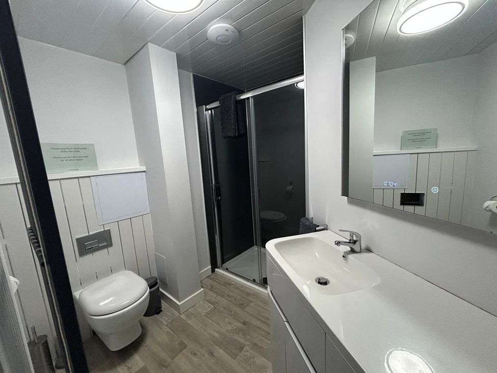 A bathroom with a toilet, sink, and shower at Wick Harbour Apt 2 Bed Fast WiFi NC500, Wick, Caithness
