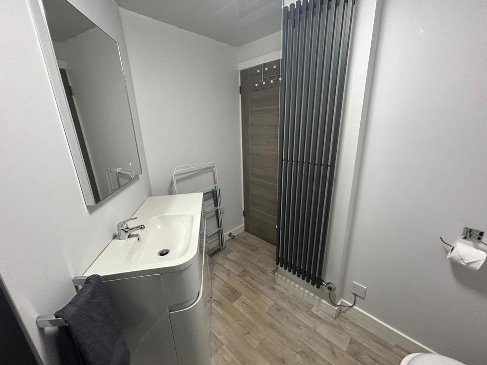 A bathroom with a sink and a mirror at Wick Harbour Apt 2 Bed Fast WiFi NC500 in Wick, Caithness