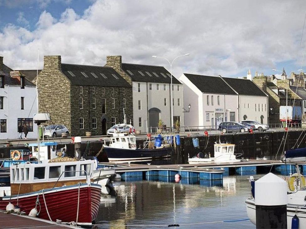 A harbor with boats and buildings at Wick Harbour Apt 2 Bed Fast WiFi NC500 in Wick, Caithness