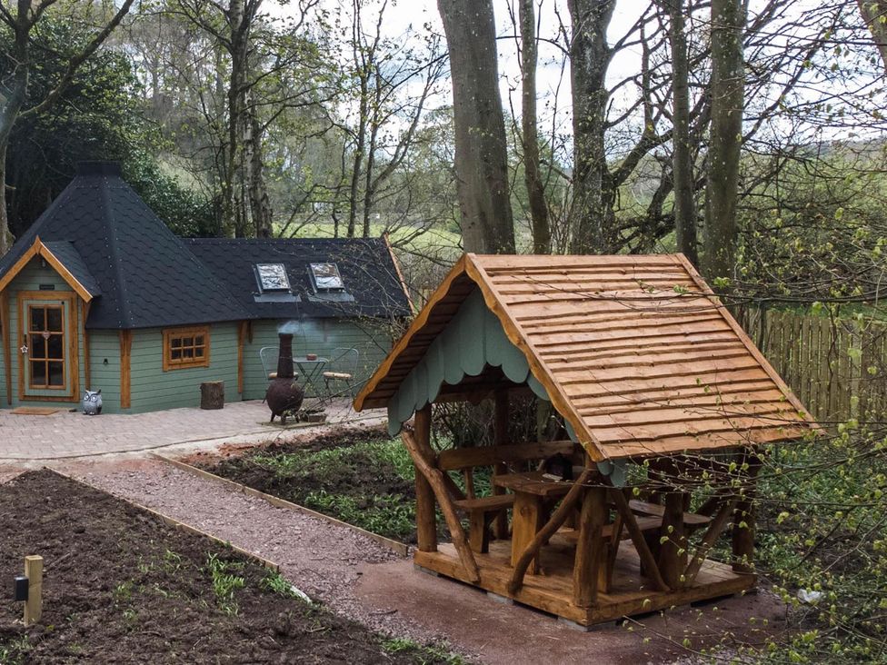 A cabin and outdoor shelter in a garden at Punch Tree Cabins Outdoor Bath Wood Burner, Carluke near Larkhall