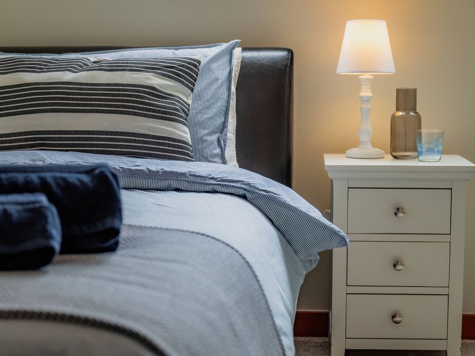 A bedroom with a bed and nightstand at 
