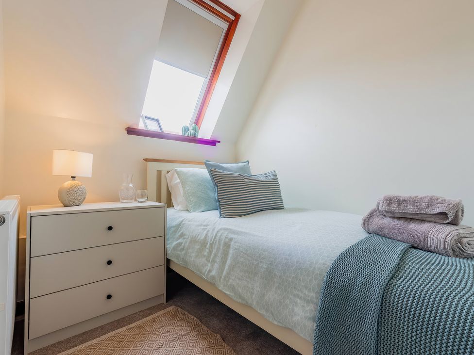 A bedroom with a single bed and nightstand at 