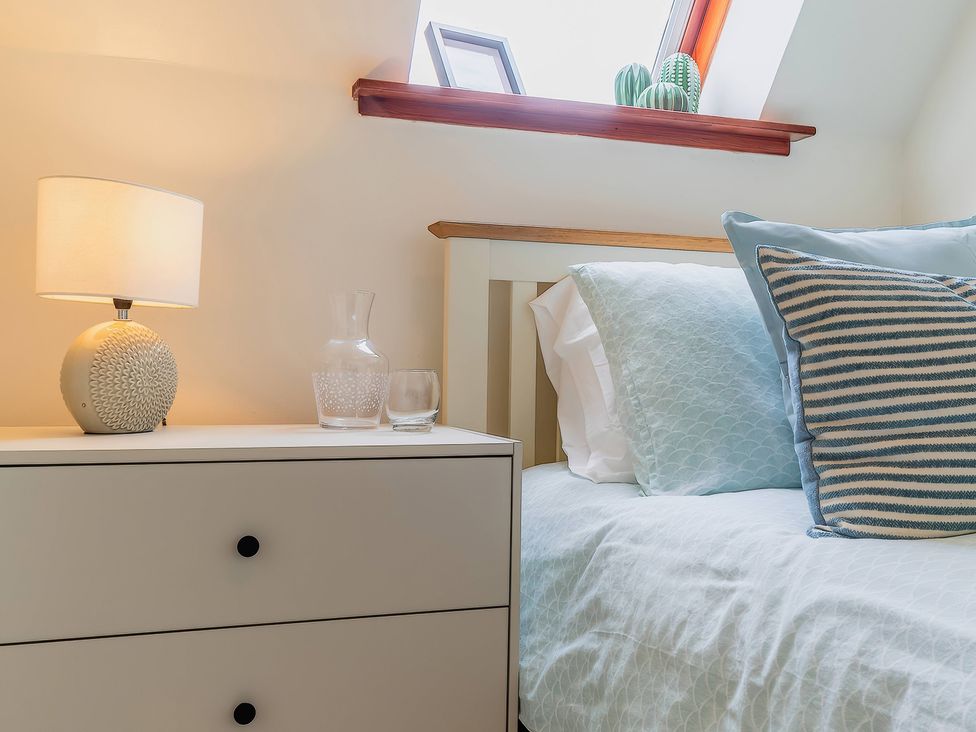 A bedroom with a bed and a nightstand at 