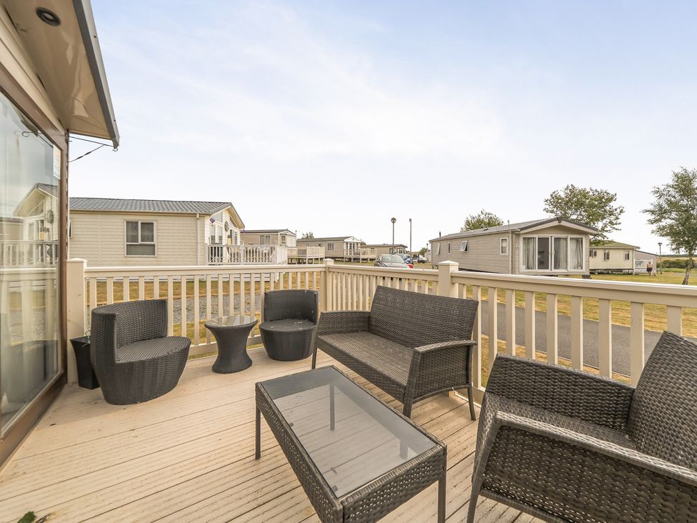 A deck with outdoor furniture at a holiday home in Tunstall, North Yorkshire