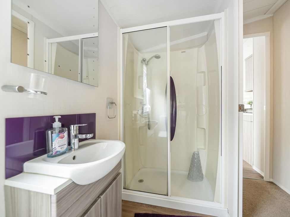 A bathroom with a shower and sink at The Old Barn in Tunstall, North Yorkshire