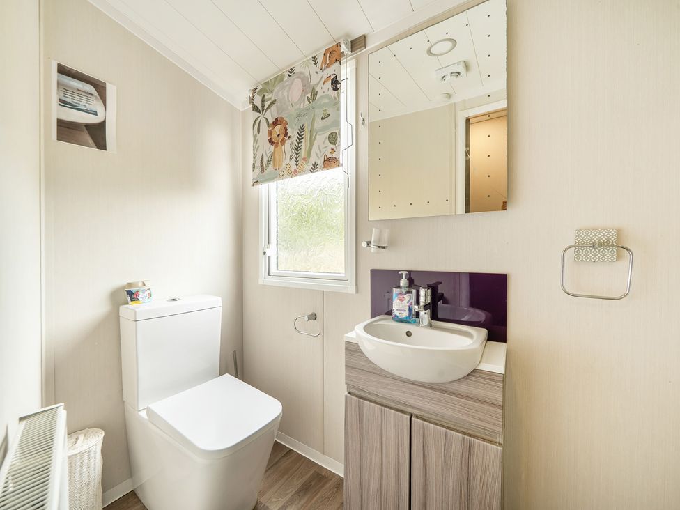 A bathroom with a toilet and sink at The Old Barn in Tunstall, North Yorkshire
