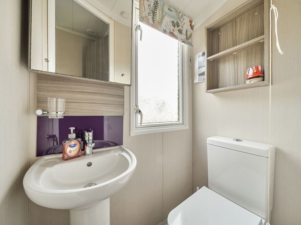 A bathroom with a sink and toilet at The Old Barn in Tunstall, North Yorkshire