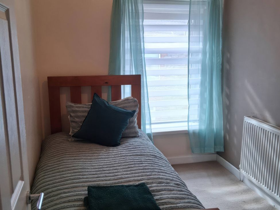 A bedroom with a bed and window at The Old Barn in Newbridge, Caerffili