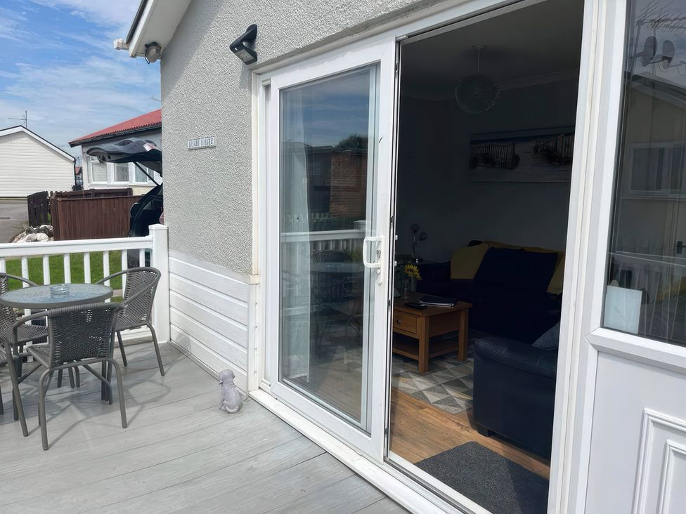 A living room with a sliding door leading to a deck at Seaside Escape 2Br Sleeps4 Parking PetsOK Fireplace in Bridlington