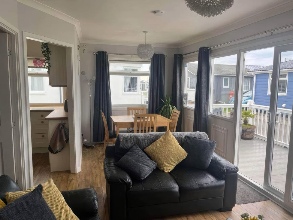 A living room with a sofa and dining table at Seaside Escape 2Br Sleeps4 Parking PetsOK Fireplace in Bridlington