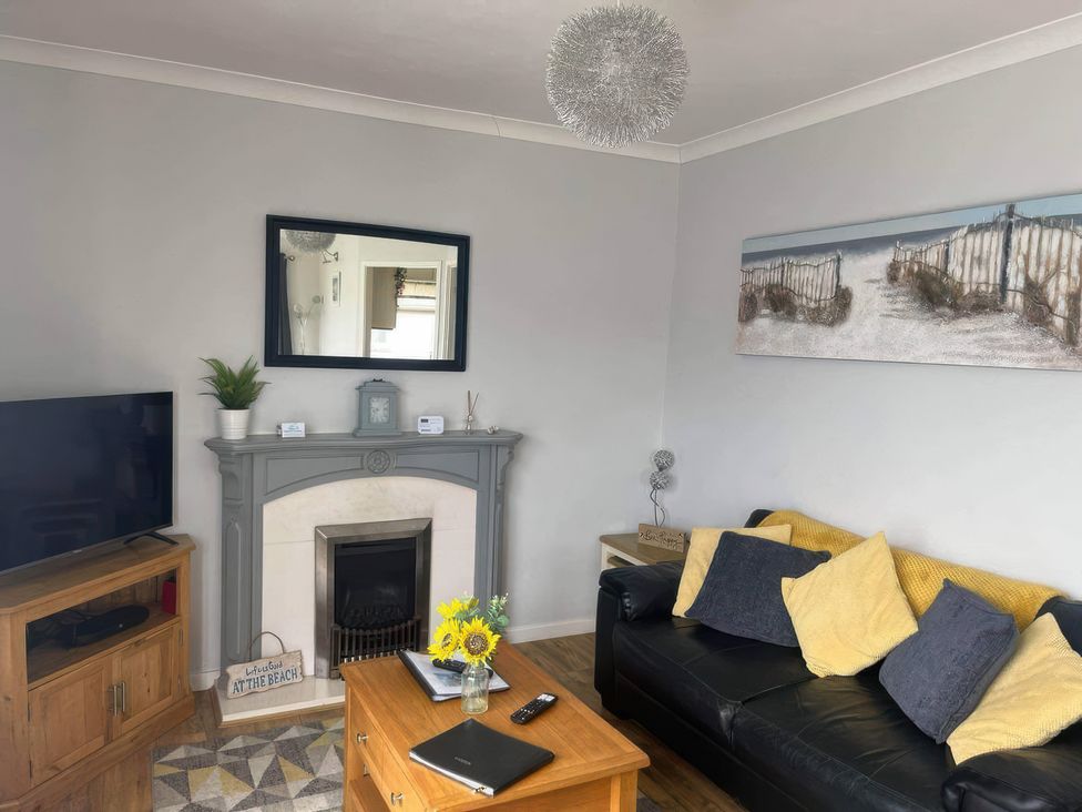 A living room with a television and coffee table at Seaside Escape 2Br Sleeps4 Parking PetsOK Fireplace in Bridlington
