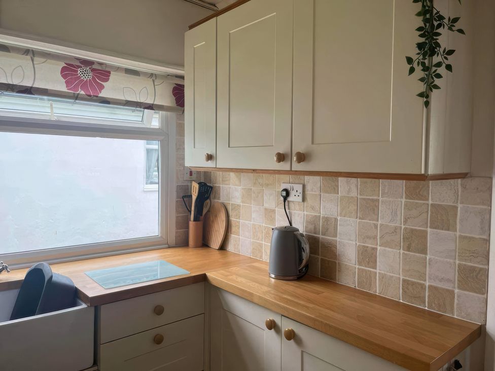 A kitchen with cabinets and a kettle at Seaside Escape 2Br Sleeps4 Parking PetsOK Fireplace in Bridlington