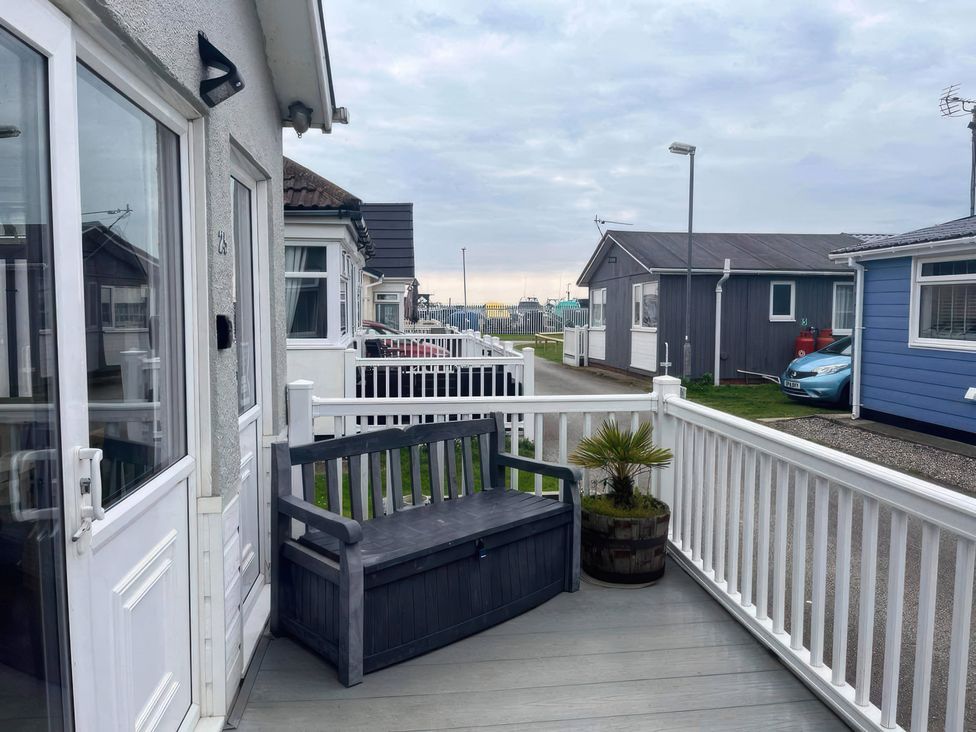 An outdoor area with a bench in front of buildings at Seaside Escape 2Br Sleeps4 Parking PetsOK Fireplace Bridlington