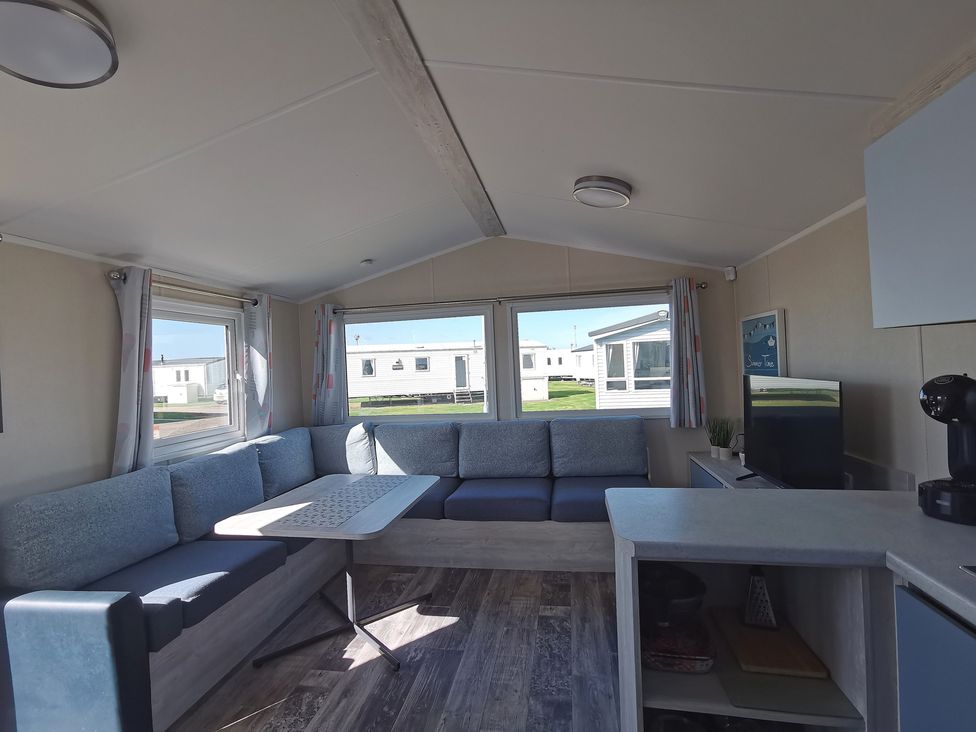 A living room with a sofa and table at the property in unspecified location