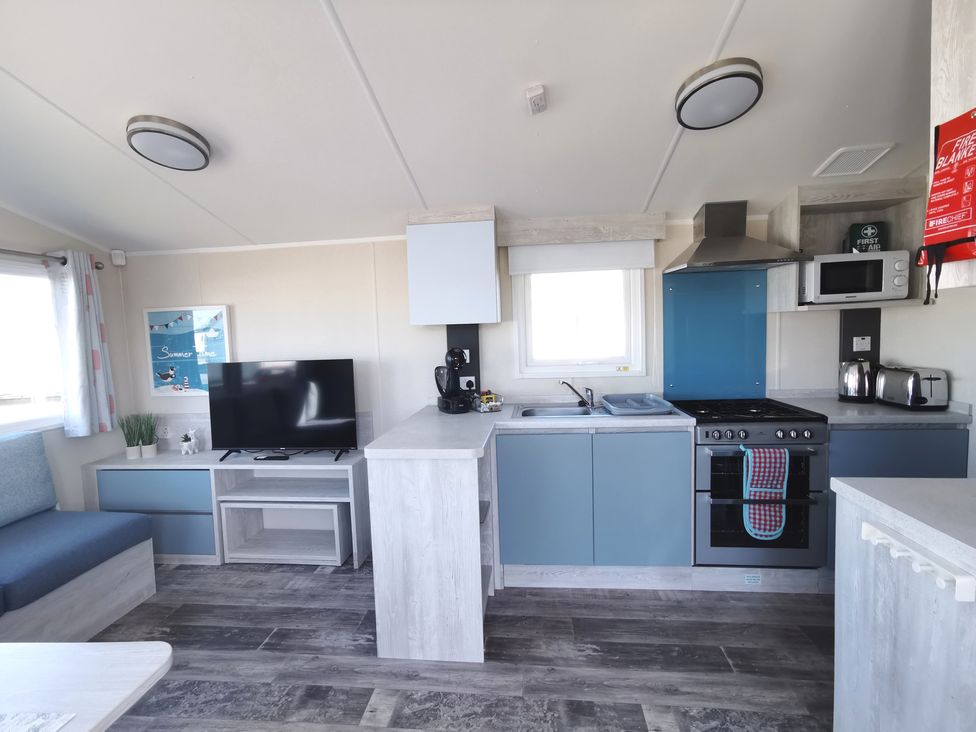 A kitchen with a stove and television at '' in ''