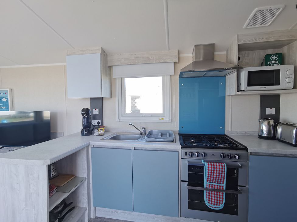 A kitchen with appliances and a television at the property