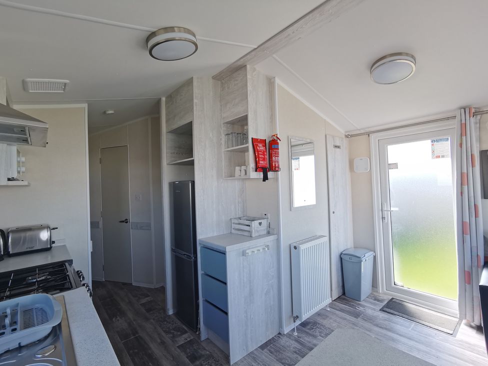 A kitchen with appliances and storage at The Old Barn in Manchester