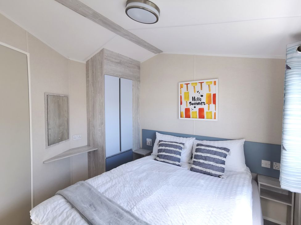 A bedroom with a bed and artwork on the wall at The Old Barn in Manchester