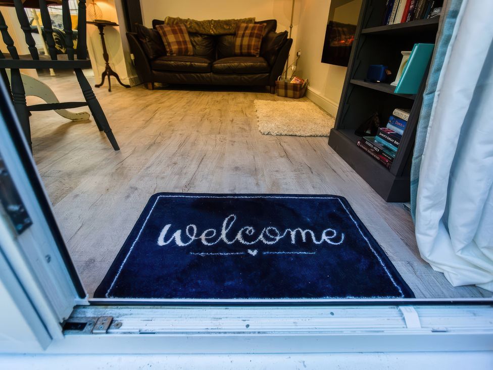 A welcome mat at the entrance of a living room at Oakley Country Retreat1 Bed Garden Free Parking in Nantwich