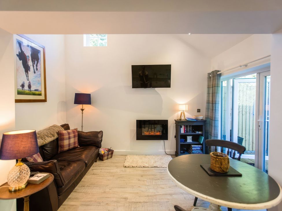 A living room with a sofa and television at Oakley Country Retreat1 Bed Garden Free Parking Nantwich