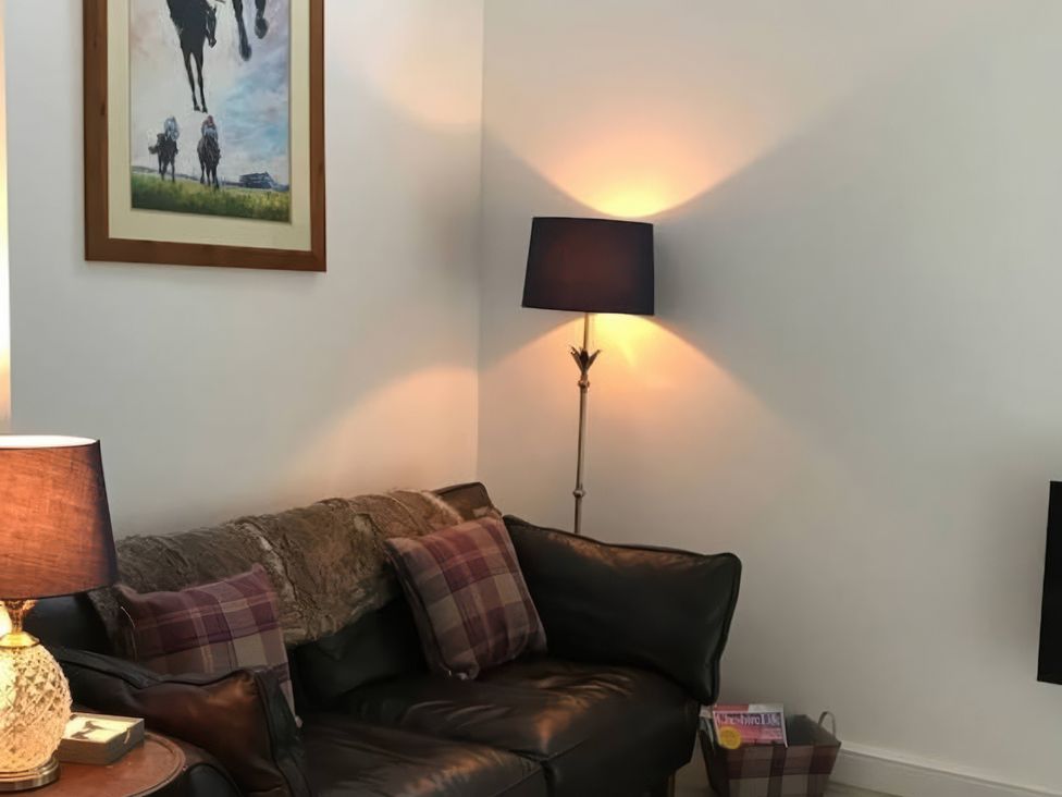 A living room with a sofa, floor lamp, and wall art at Oakley Country Retreat1 Bed Garden Free Parking in Nantwich