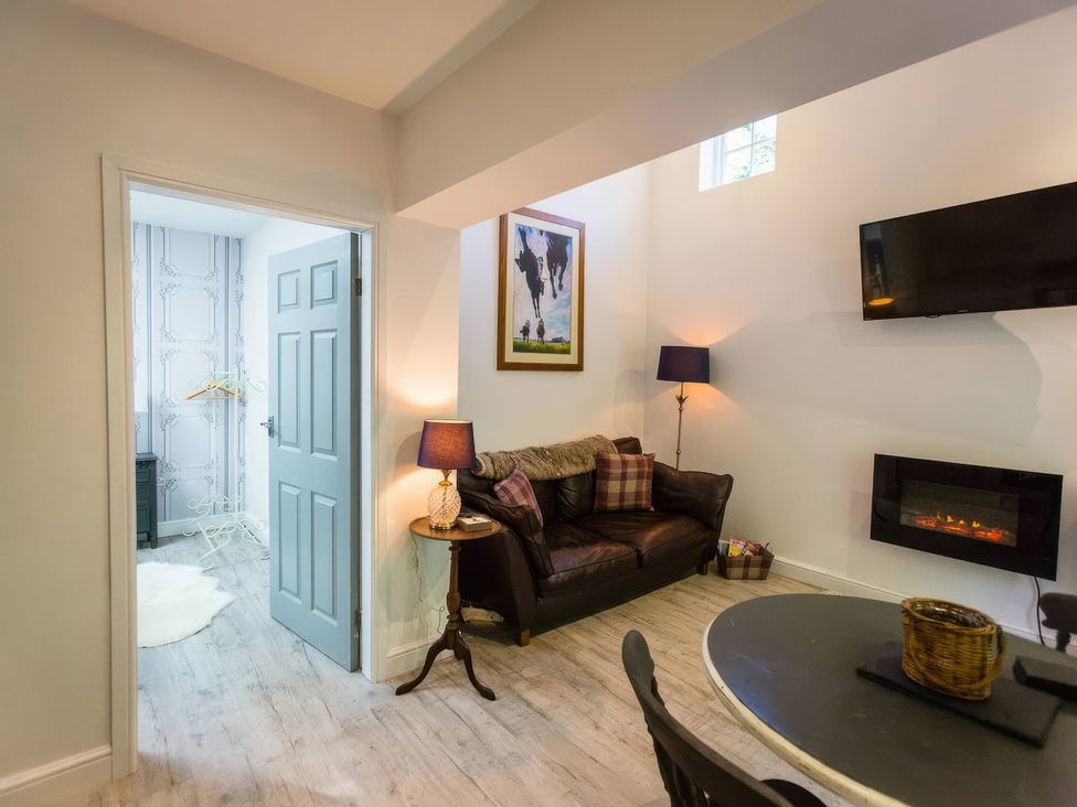 A living room with a sofa and a television at Oakley Country Retreat1 Bed Garden Free Parking, Nantwich