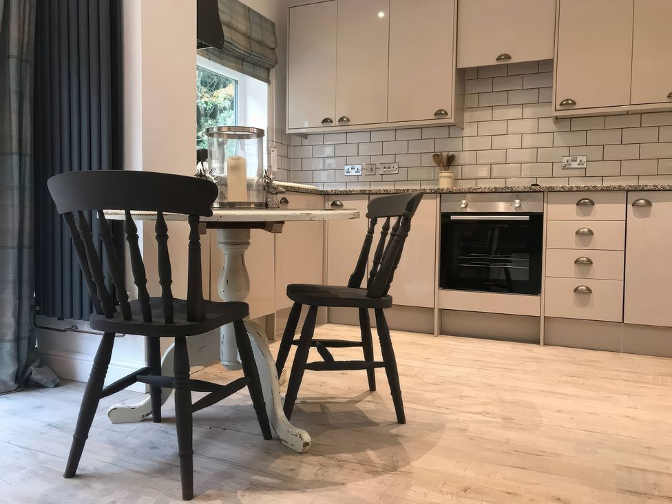 A kitchen with a table and chair at Oakley Country Retreat1 Bed Garden Free Parking Nantwich