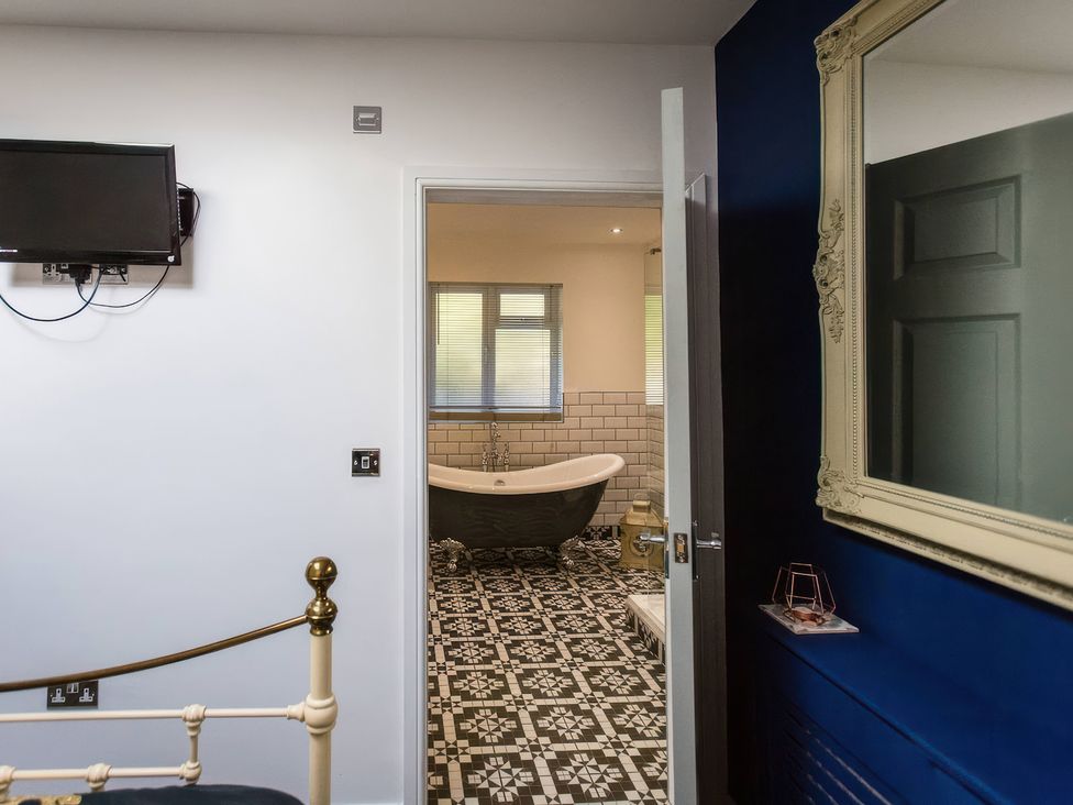 A view of a bathroom with a bathtub and tiles at Oakley Country Retreat1 Bed Garden Free Parking Nantwich