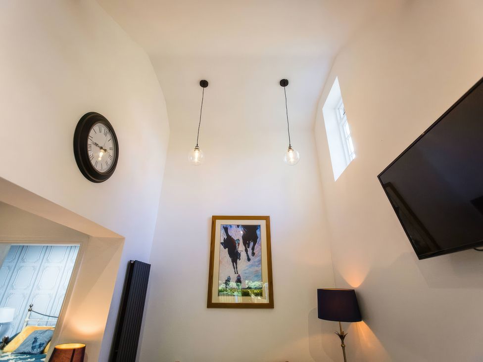 A living room with a clock and artwork at Oakley Country Retreat1 Bed Garden Free Parking Nantwich