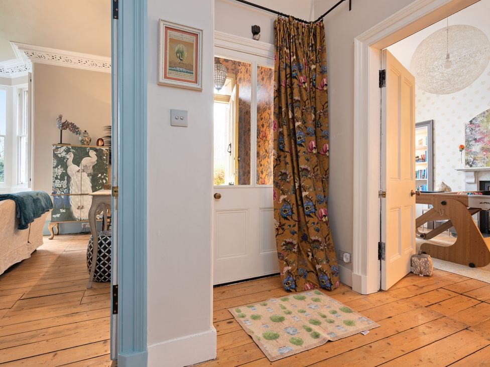 A hallway with a curtain and door at 