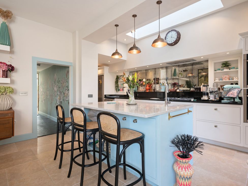 A kitchen with a central island and bar stools at 