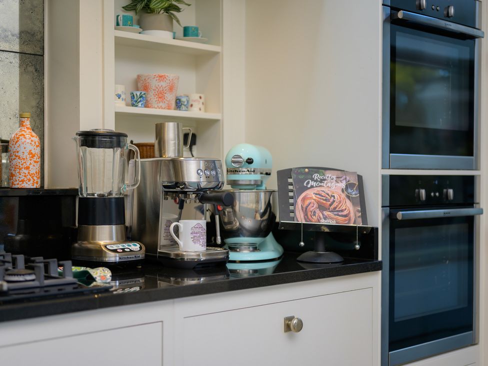 A kitchen with appliances and a recipe book at 