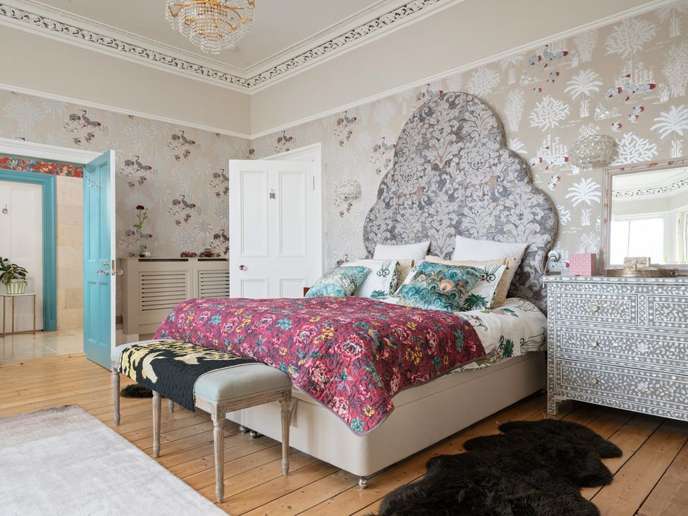 A bedroom with a bed and nightstand at The Old Barn in Manchester