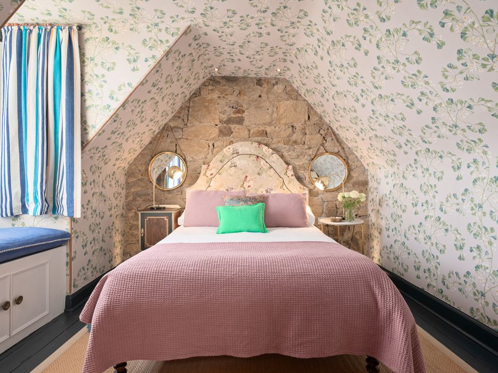 A bedroom with a bed and mirrors at The Old Barn in Manchester