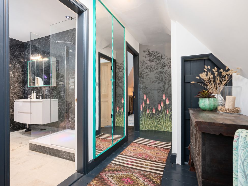 A bathroom with a shower, sink, and decorative wall at unspecified location