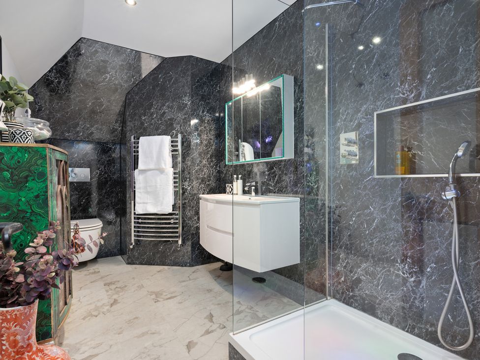 A bathroom with a shower and towel radiator at 