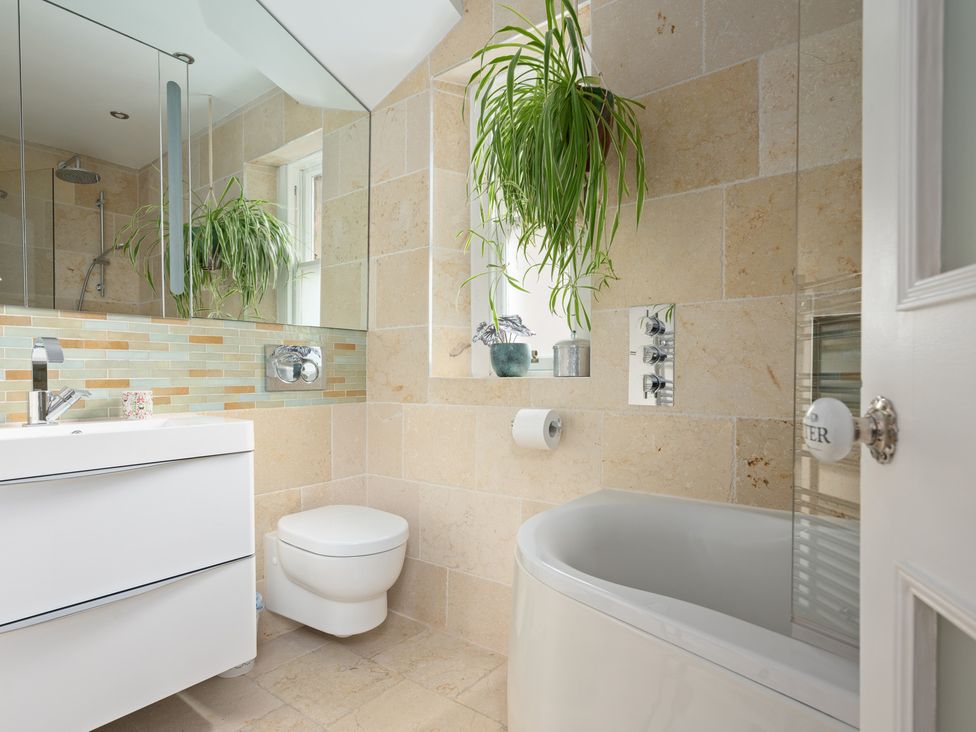 A bathroom with a bathtub, toilet, and sink at 