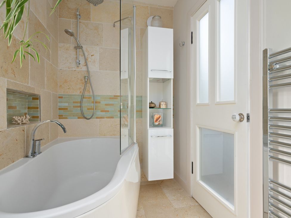 A bathroom with a bathtub and shower at The Old Barn in Manchester