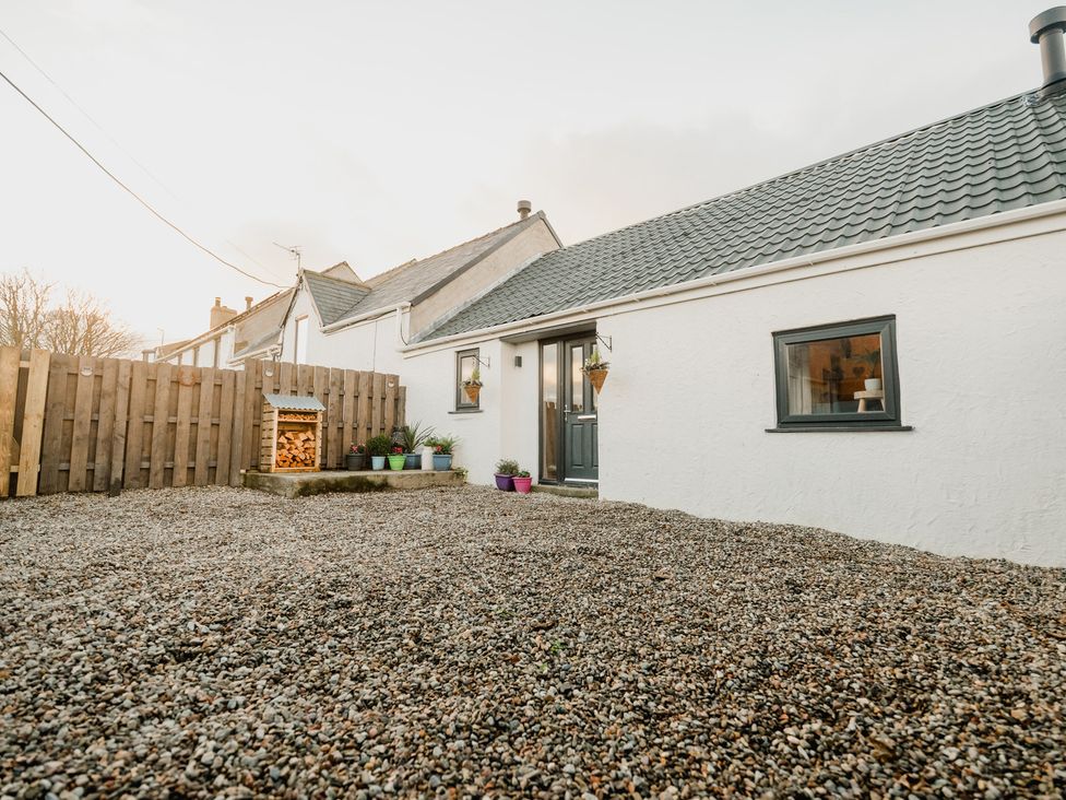 An outdoor area with gravel and a wooden fence at 