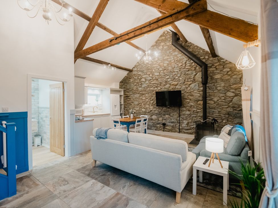A living room with a sofa and dining table at the property