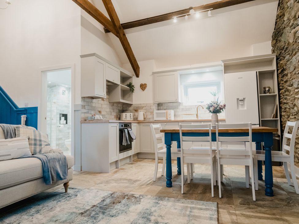 A kitchen with a wooden table and chairs at the property in an unspecified location