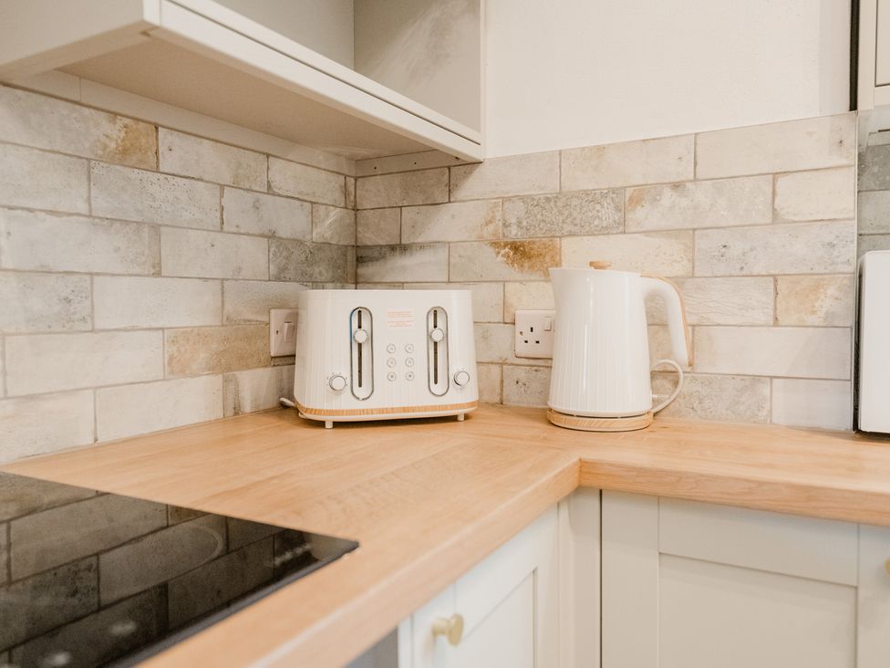 A kitchen with a toaster and kettle on the countertop at 