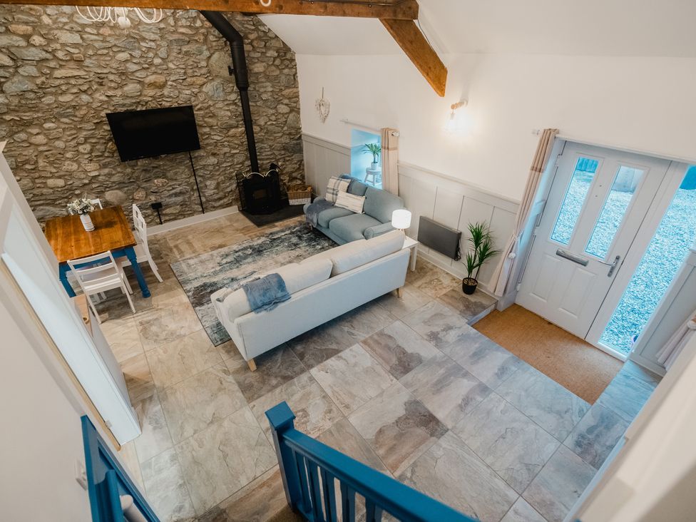 A living room with a television and fireplace at The Old Barn in Manchester