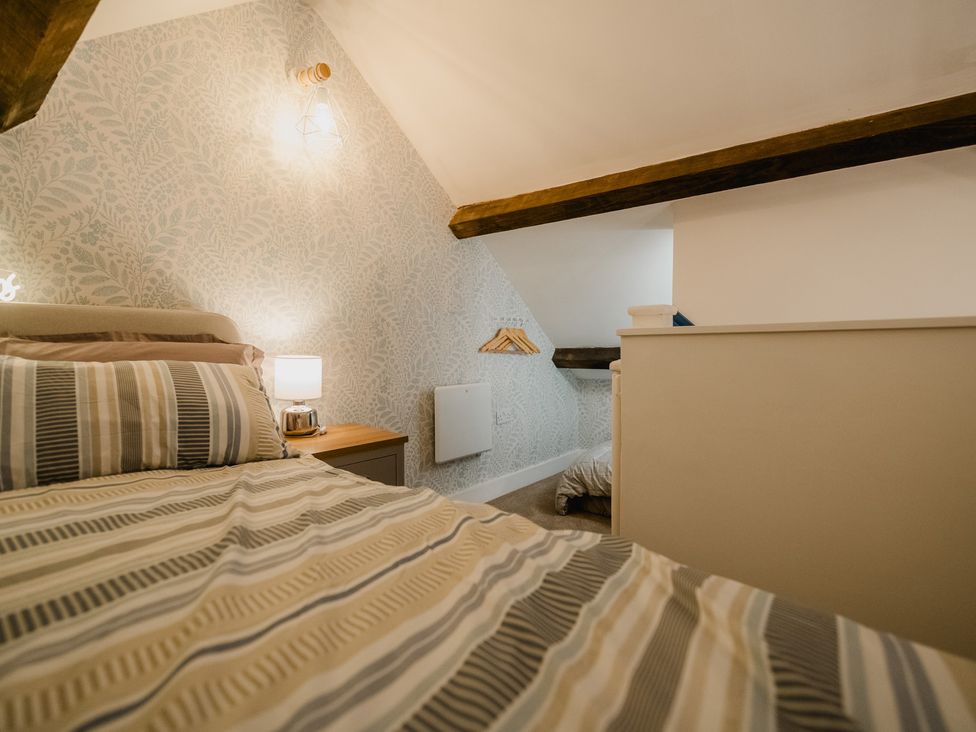 A bedroom with a bed and bedside table at The Old Barn in Manchester