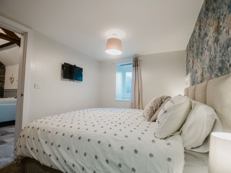 A bedroom with a bed and television at a property