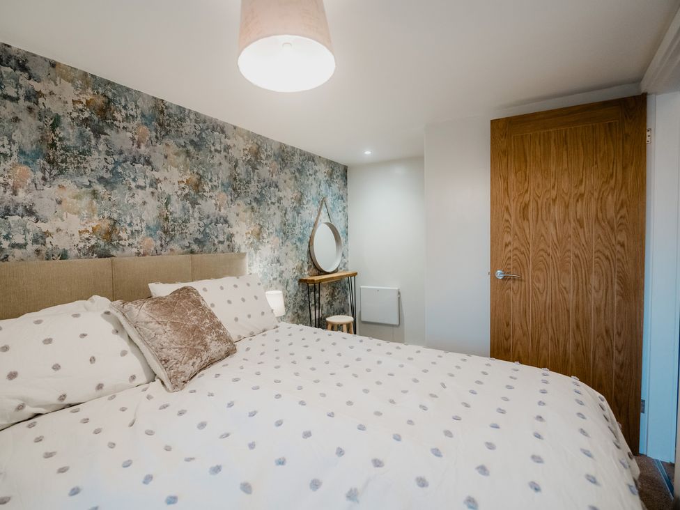 A bedroom with a bed and a mirror at the property