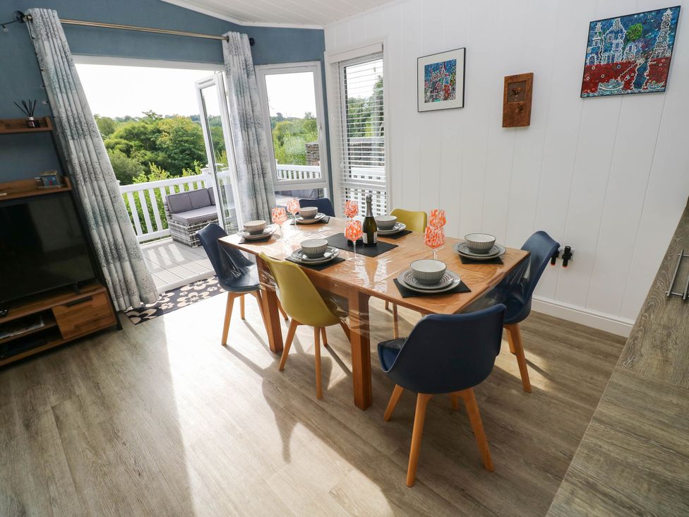 A dining room with a table and chairs at Pleasant Valley Holiday Lodge 70, Stepaside